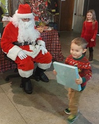 image of Santa Claus handing out presents.