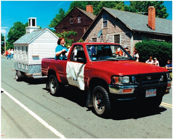 image of the mini Montville Church being towed by a pickup truck.