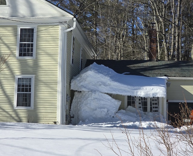 image of snow hanging over a row of windows.