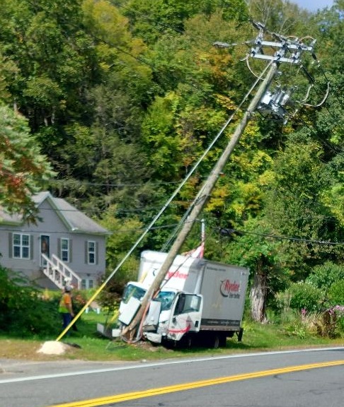 image of a ttruck crashed into a pole.