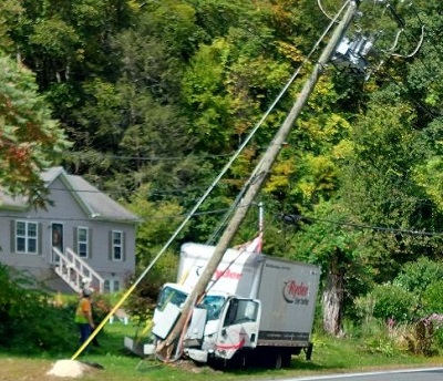 image of a truck crashed into a pole.