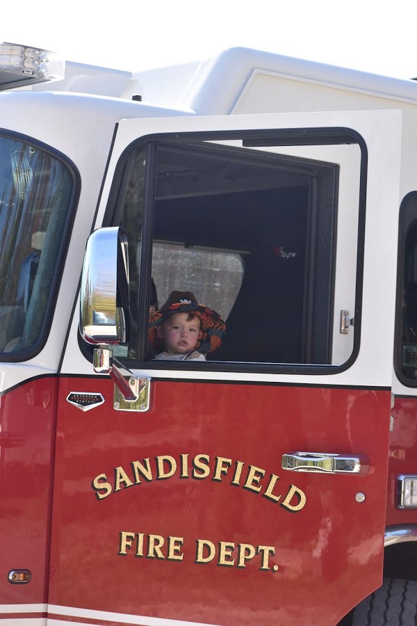 image of a boy in a fire truck.