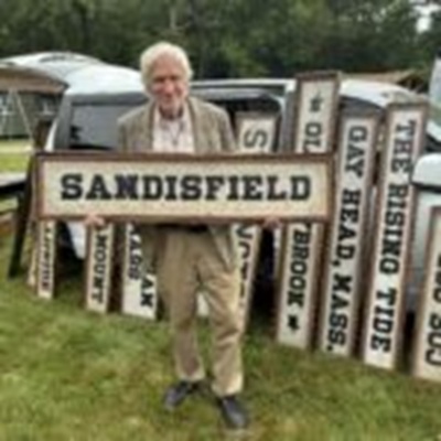image of Will Noad holding a Sandisfield sign.