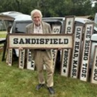 image of Will Noad holding a Sandisfield sign.