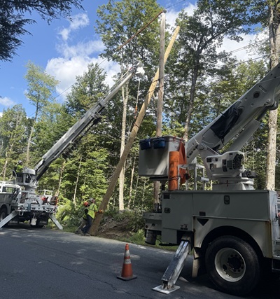 image of workers installing a telephone pole.